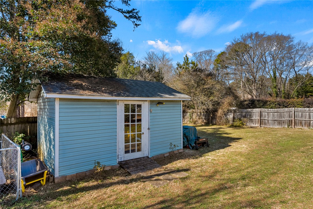 112 C-10-220 Anderson, SC 29621 - Photo 44 of 45 This tranquil backyard offers a practical shed and a lush lawn, perfect for outdoor living.