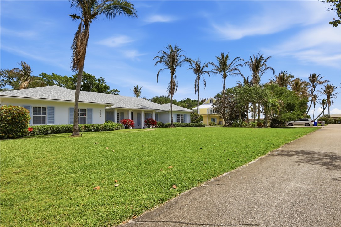 2116 Cavalla Road Vero Beach, FL 32963 - Photo 22 of 23 a front view of a house with a garden and yard