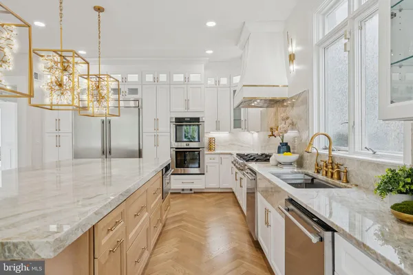 a kitchen with stainless steel appliances granite countertop a refrigerator and a sink