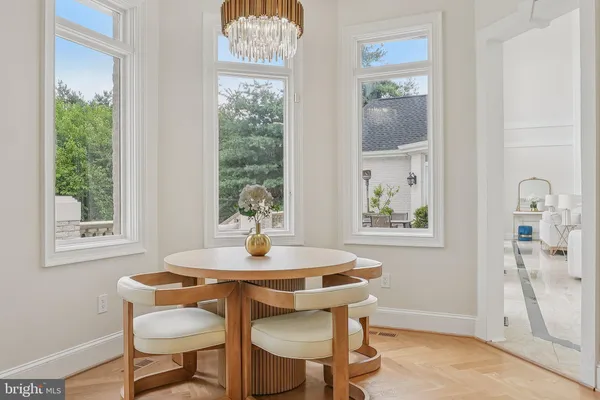 a view of a sink a table and chair in a room