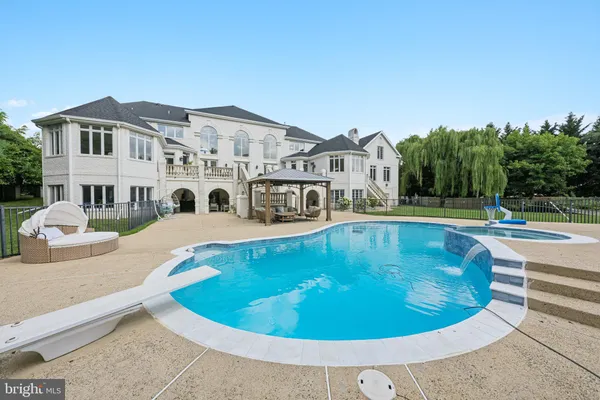 a view of a house with swimming pool and a yard