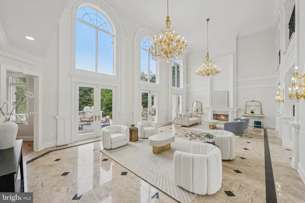a living room with furniture and chandelier