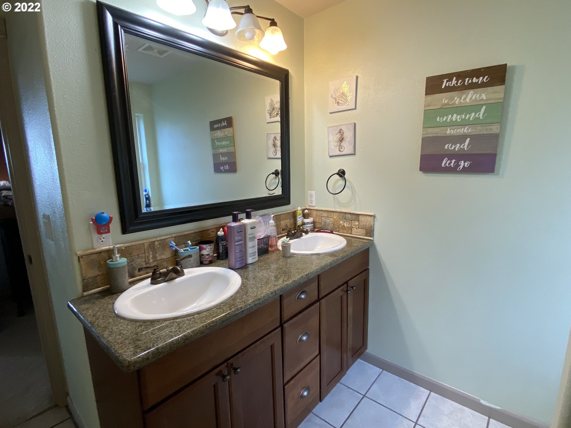 1548 Northeast Rocky Ridge Drive Roseburg, OR 97470 - Photo 28 of 31 a bathroom with a granite countertop sink a mirror and a