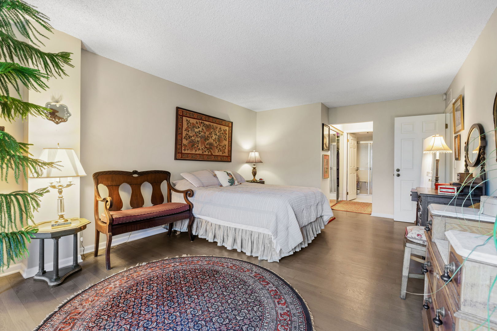 710 Waukegan Road, Unit 201 Glenview, IL 60025 - Photo 12 of 20 a spacious bedroom with a bed a couch and a potted plant