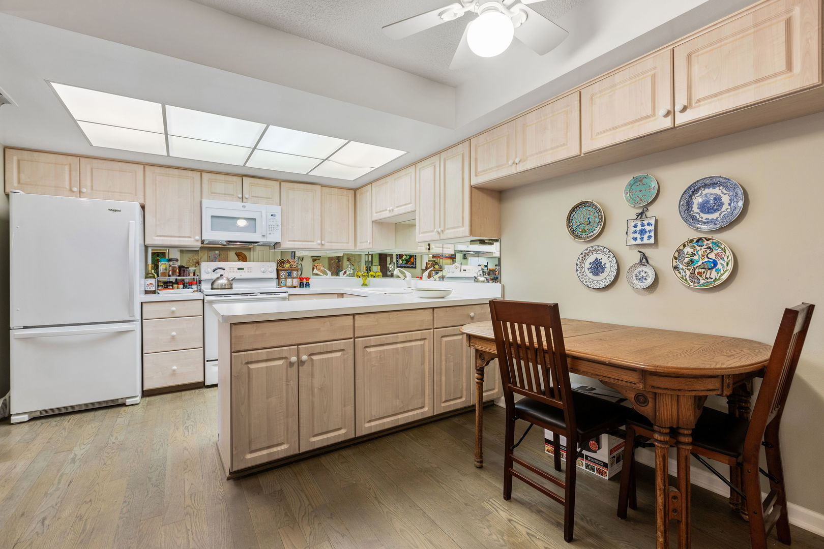 710 Waukegan Road, Unit 201 Glenview, IL 60025 - Photo 8 of 20 a kitchen with a white cabinets and chairs