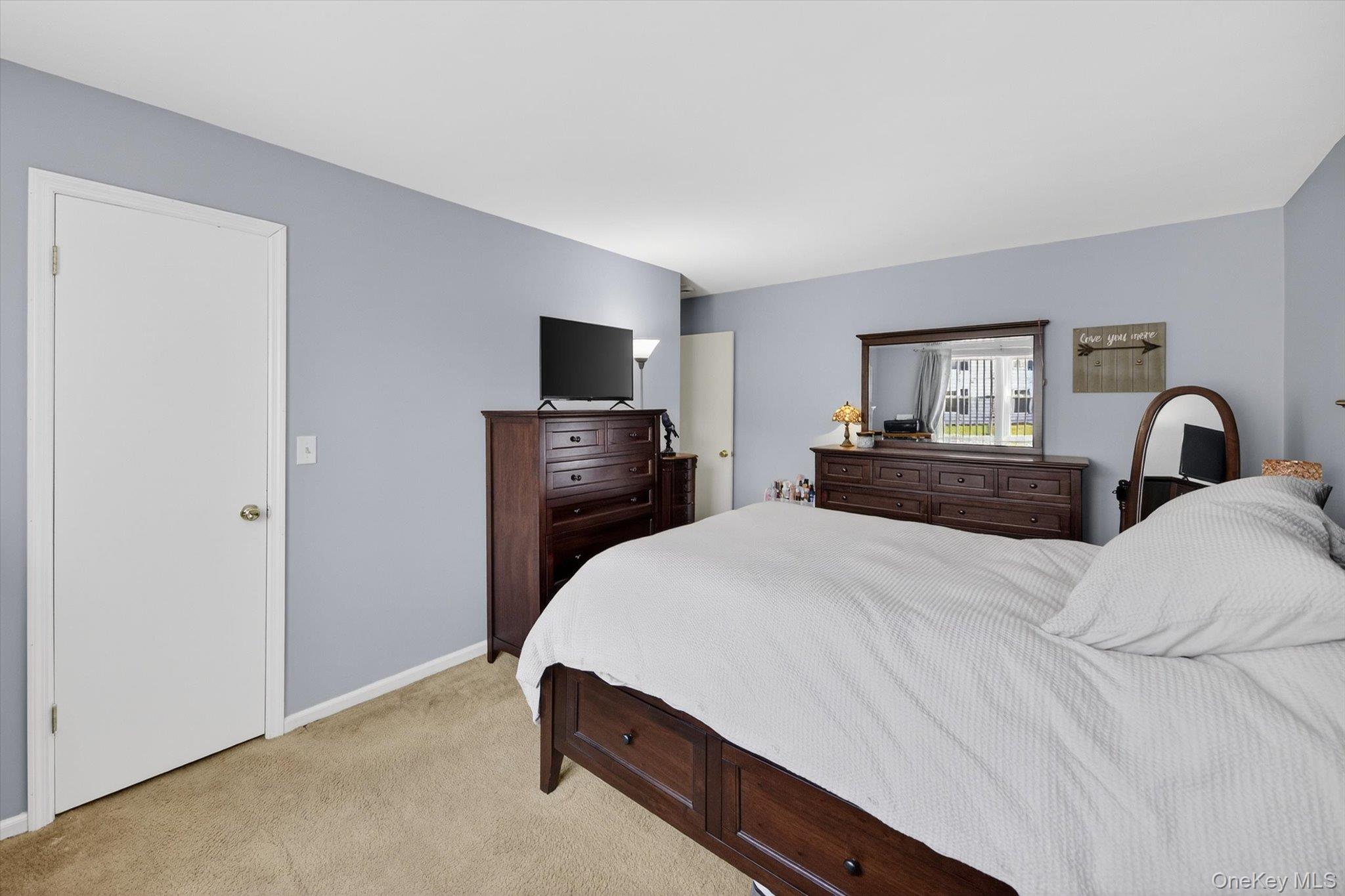 276 Temple Hill Road, Unit 1515 New Windsor, NY 12553 - Photo 18 of 28 a bedroom with a bed and a flat screen tv