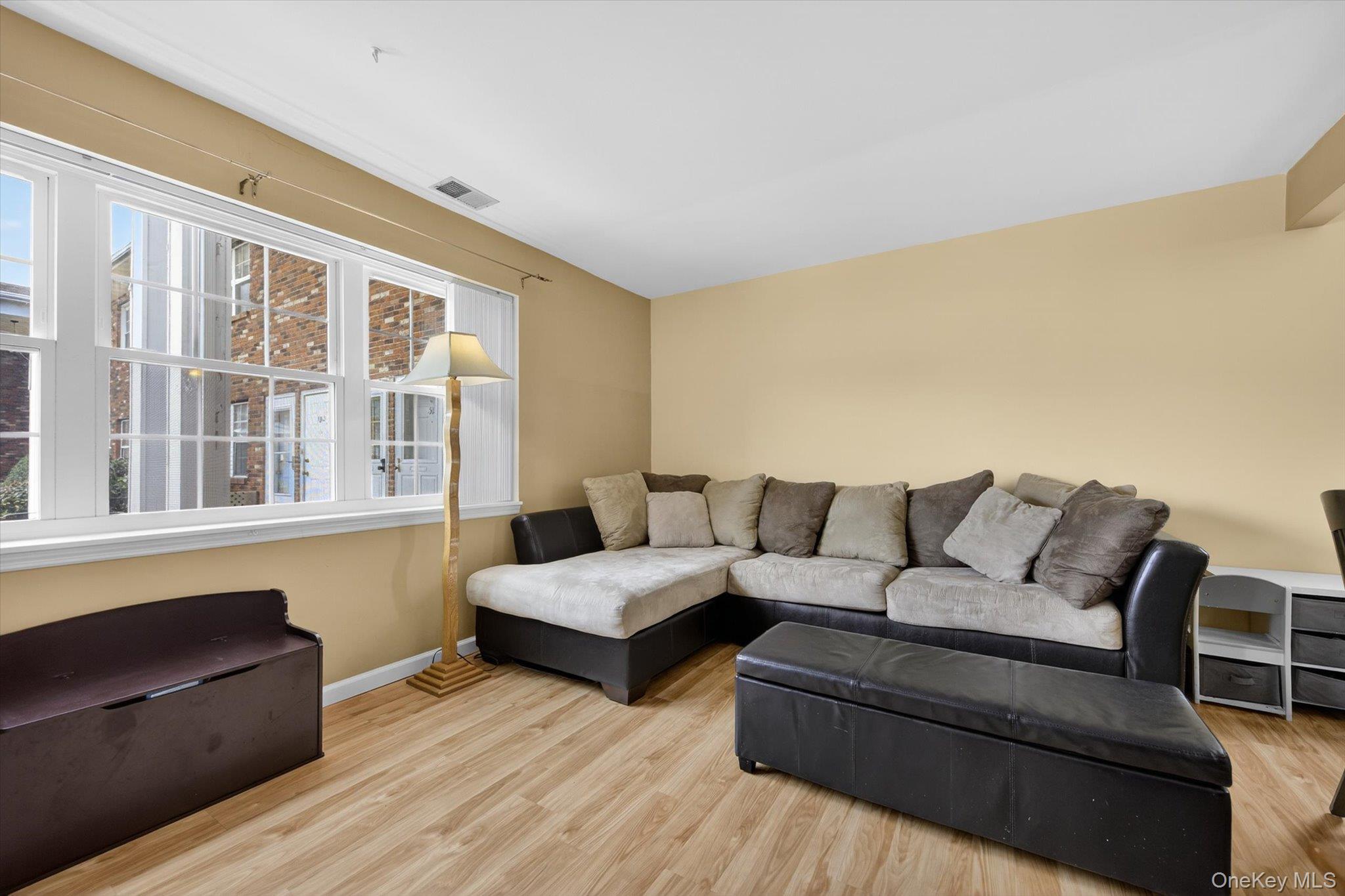 276 Temple Hill Road, Unit 1515 New Windsor, NY 12553 - Photo 6 of 28 a living room with couches and a large window with kitchen view