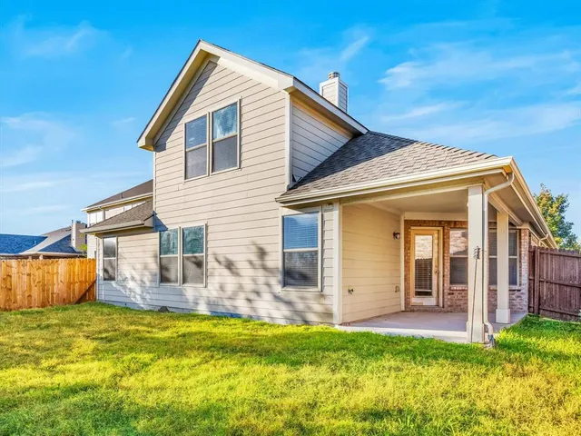 a view of a house with pool and a yard