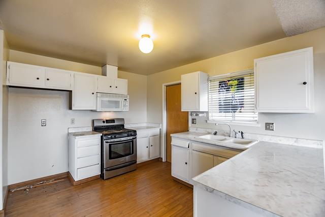 1500 Soto Street Seaside, CA 93955 - Photo 11 of 30 a kitchen that has a sink a stove and a refrigerator