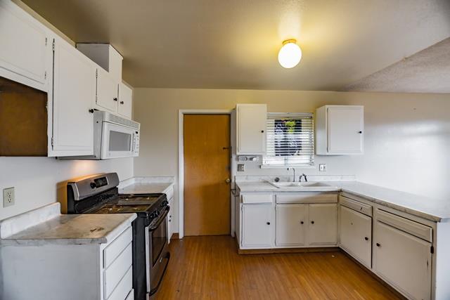 1500 Soto Street Seaside, CA 93955 - Photo 13 of 30 a kitchen with a sink a stove and cabinets