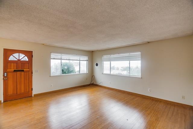 1500 Soto Street Seaside, CA 93955 - Photo 14 of 30 a view of an empty room with wooden floor and a window