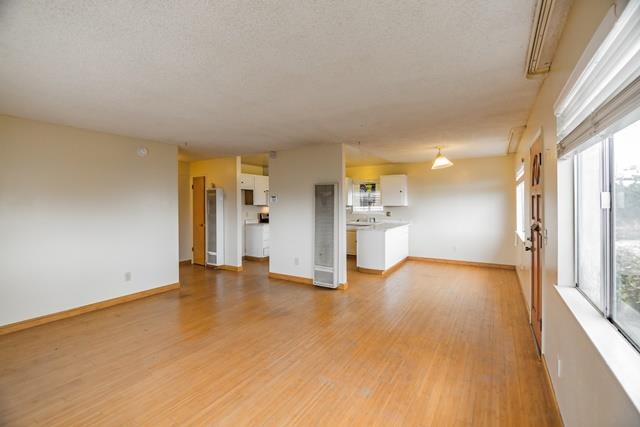 1500 Soto Street Seaside, CA 93955 - Photo 15 of 30 a view of empty room with wooden floor and windows