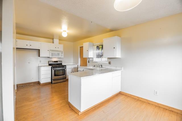 1500 Soto Street Seaside, CA 93955 - Photo 9 of 30 a kitchen with stainless steel appliances a sink a stove a refrigerator cabinets and a counter top space