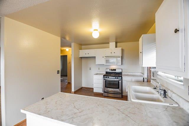 1500 Soto Street Seaside, CA 93955 - Photo 10 of 30 a kitchen with stainless steel appliances kitchen island granite countertop a sink and a refrigerator