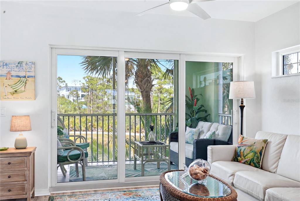 8405 Placida Road, Unit 204 Placida, FL 33946 - Photo 11 of 49 a living room with furniture and a large window