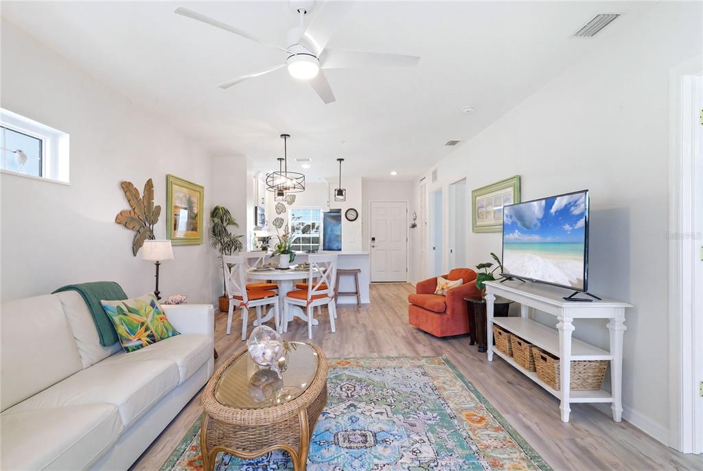 8405 Placida Road, Unit 204 Placida, FL 33946 - Photo 13 of 49 a living room with furniture a rug and a chandelier