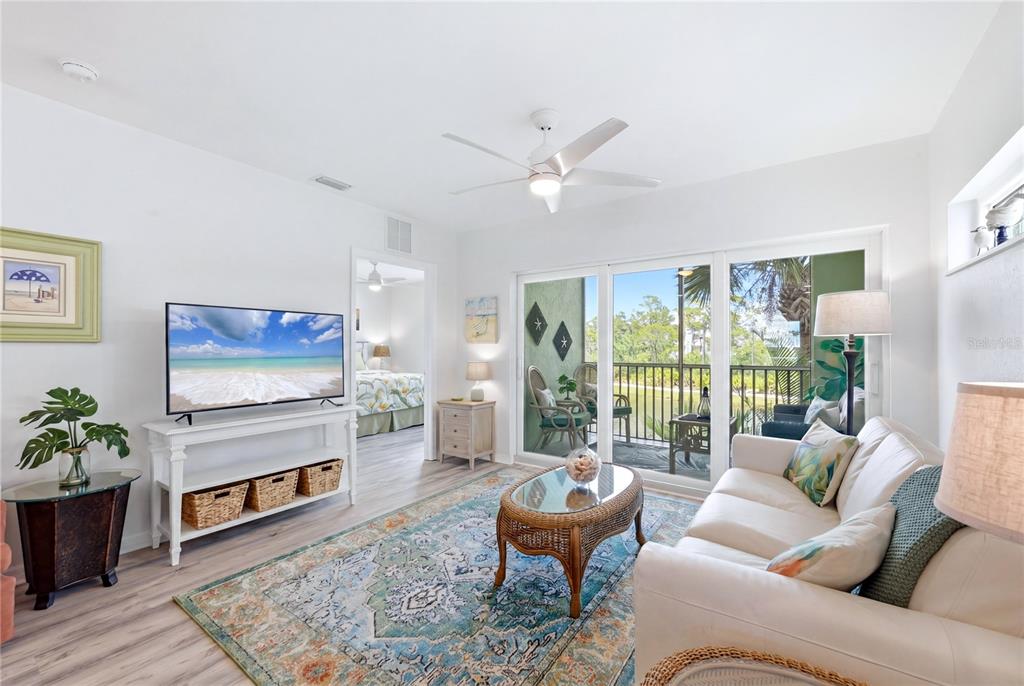 8405 Placida Road, Unit 204 Placida, FL 33946 - Photo 16 of 49 a living room with furniture a fireplace and a large window