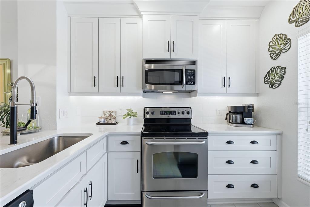 8405 Placida Road, Unit 204 Placida, FL 33946 - Photo 22 of 49 a kitchen with cabinets stainless steel appliances and a sink
