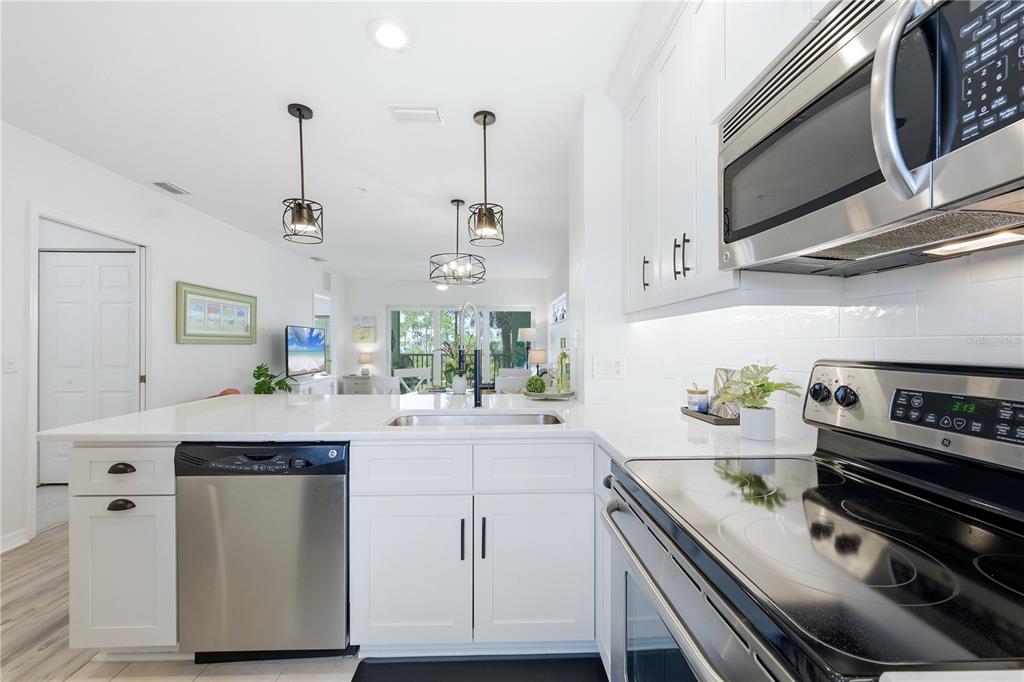8405 Placida Road, Unit 204 Placida, FL 33946 - Photo 23 of 49 a kitchen with a sink appliances and cabinets