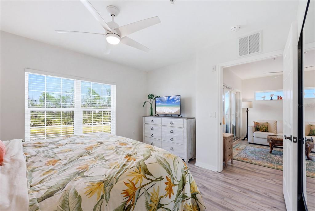 8405 Placida Road, Unit 204 Placida, FL 33946 - Photo 26 of 49 a bedroom with a bed and wooden floor