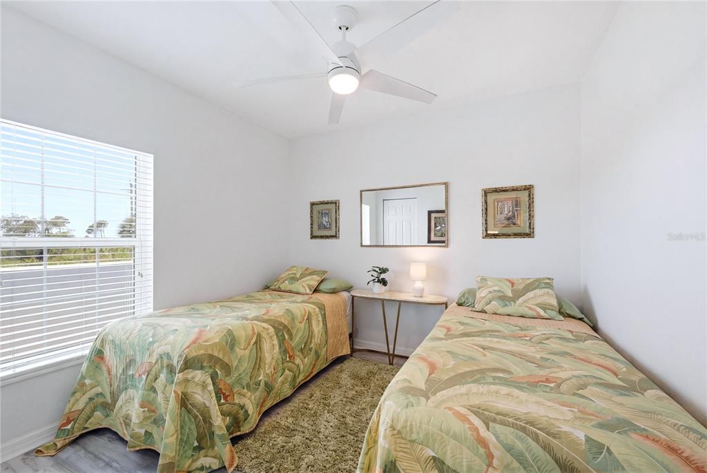 8405 Placida Road, Unit 204 Placida, FL 33946 - Photo 31 of 49 a bedroom with two beds and a large window