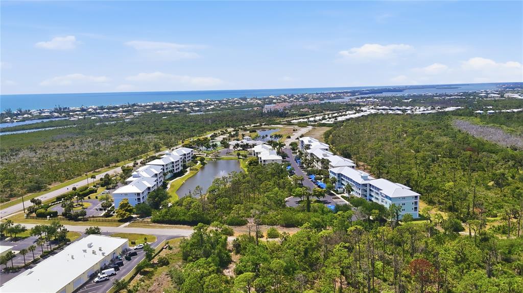 8405 Placida Road, Unit 204 Placida, FL 33946 - Photo 38 of 49 an aerial view of residential building with outdoor space and trees