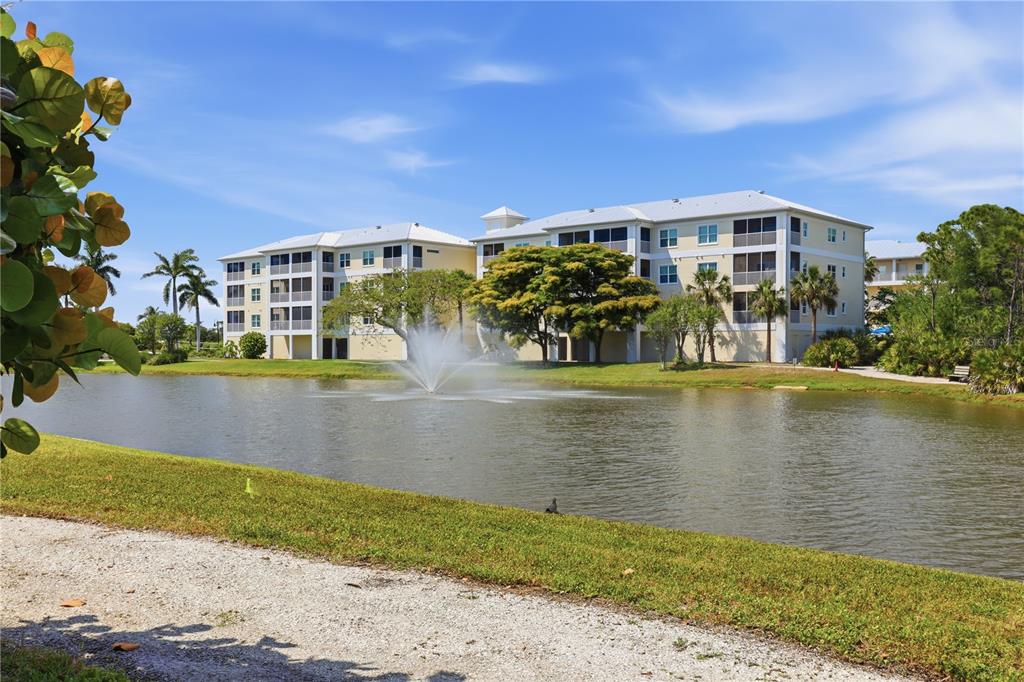 8405 Placida Road, Unit 204 Placida, FL 33946 - Photo 40 of 49 a view of swimming pool with outdoor seating and lake view