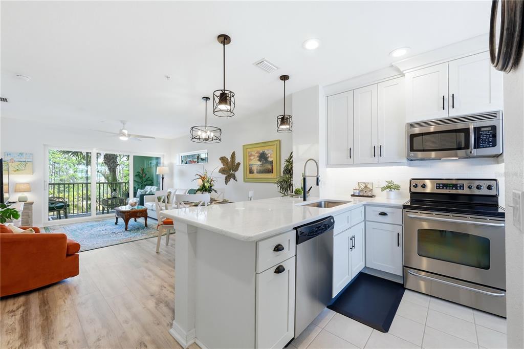 8405 Placida Road, Unit 204 Placida, FL 33946 - Photo 6 of 49 a kitchen with a sink cabinets and window