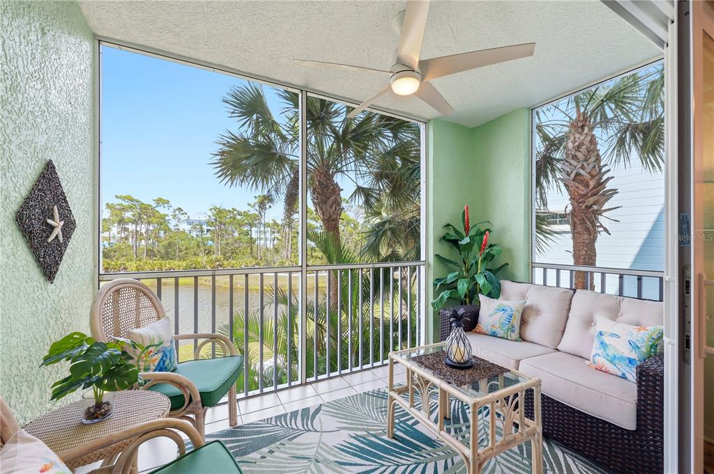 8405 Placida Road, Unit 204 Placida, FL 33946 - Photo 8 of 49 a balcony with furniture and a potted plant
