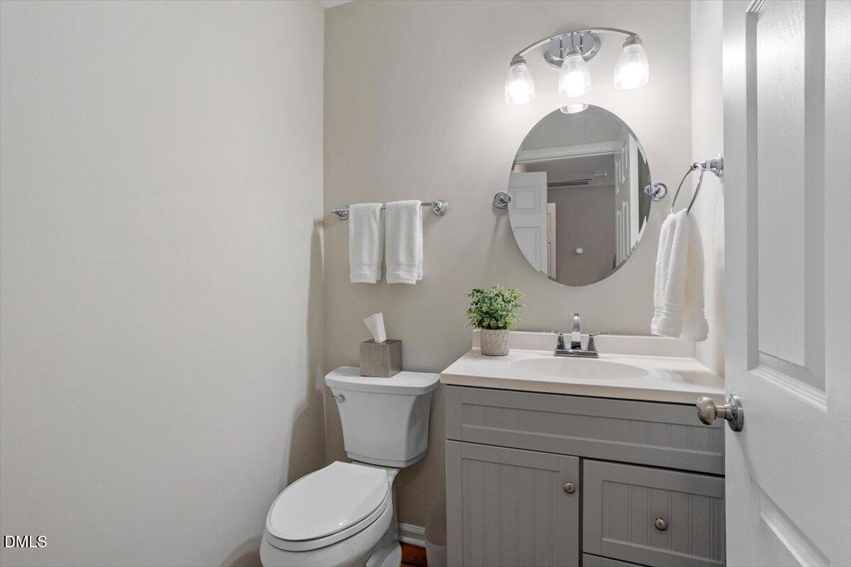 8321 Hempshire Place, Unit 103 Raleigh, NC 27613 - Photo 13 of 25 a bathroom with a toilet sink and mirror