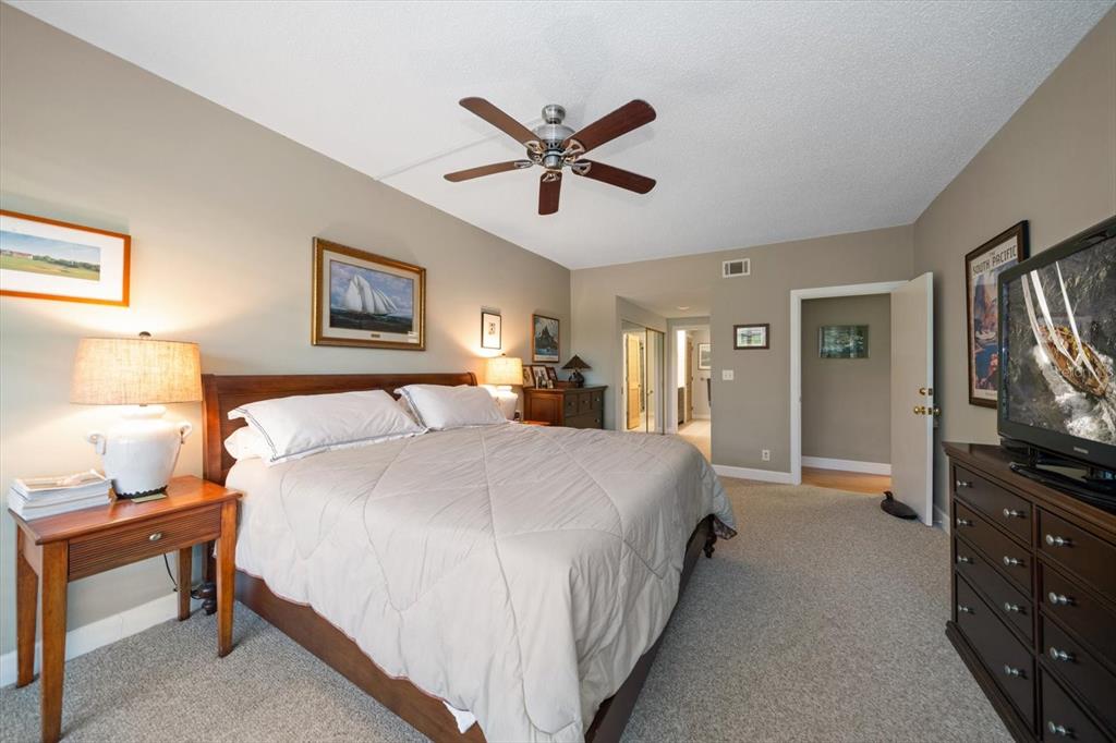 50 Coe Road, Unit 311 Belleair, FL 33756 - Photo 19 of 53 a bedroom with a bed and a tv on the dresser