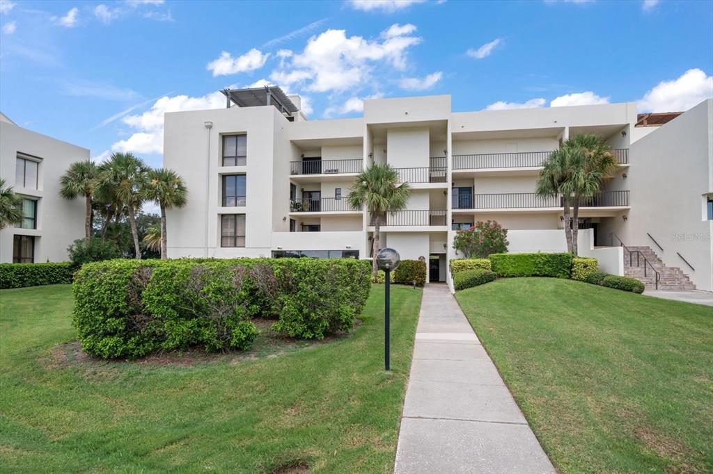 50 Coe Road, Unit 311 Belleair, FL 33756 - Photo 44 of 53 a front view of a house with a yard