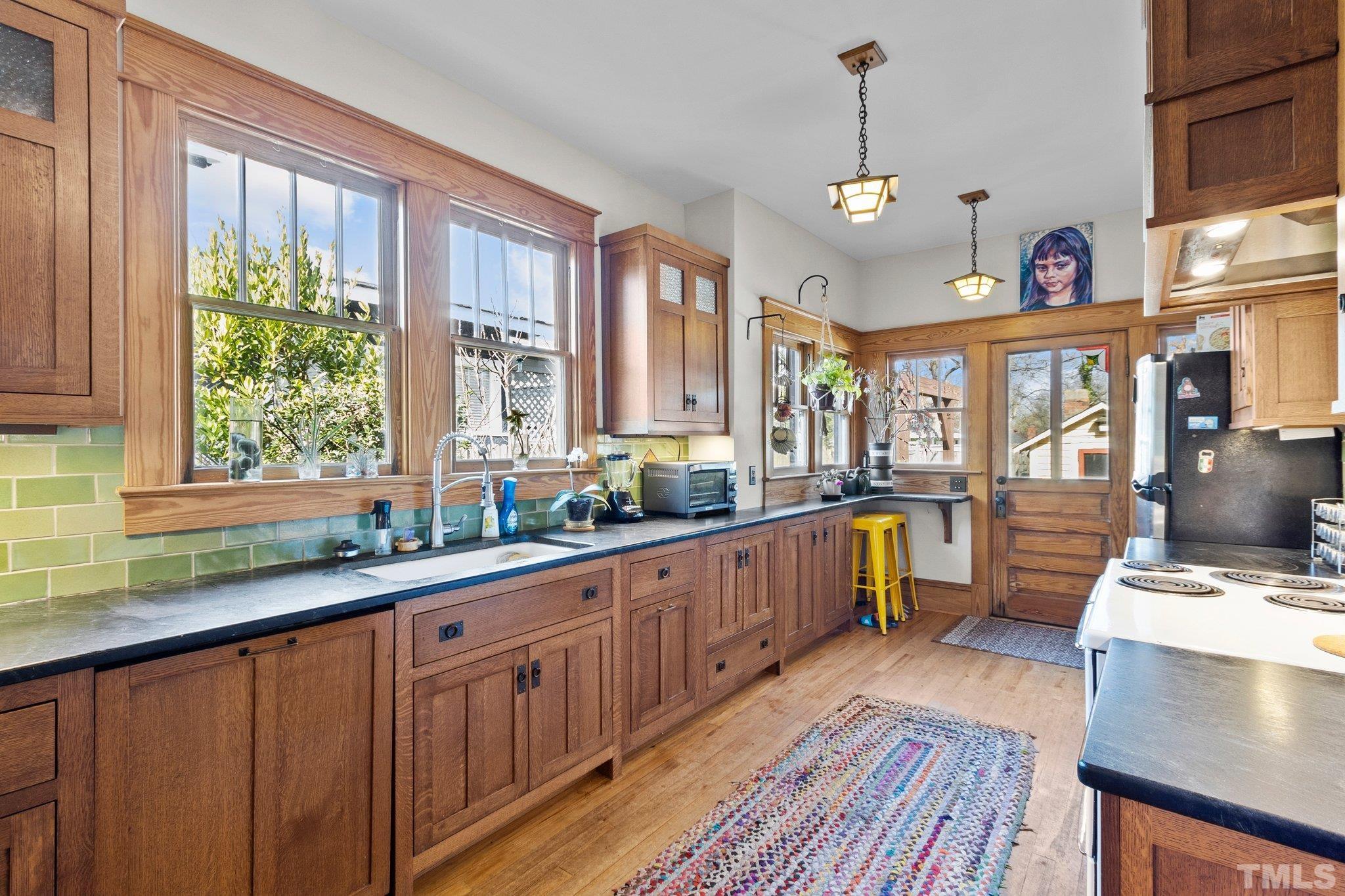 543 East Jones Street Raleigh, NC 27601 - Photo 11 of 31 a kitchen with sink cabinets and wooden floor
