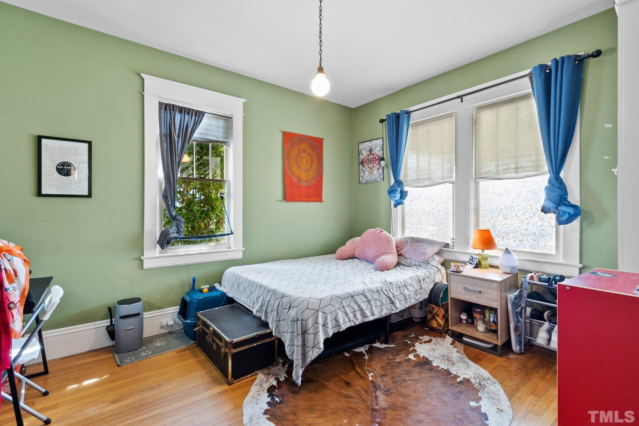 543 East Jones Street Raleigh, NC 27601 - Photo 20 of 31 a bedroom with a bed and wooden floor
