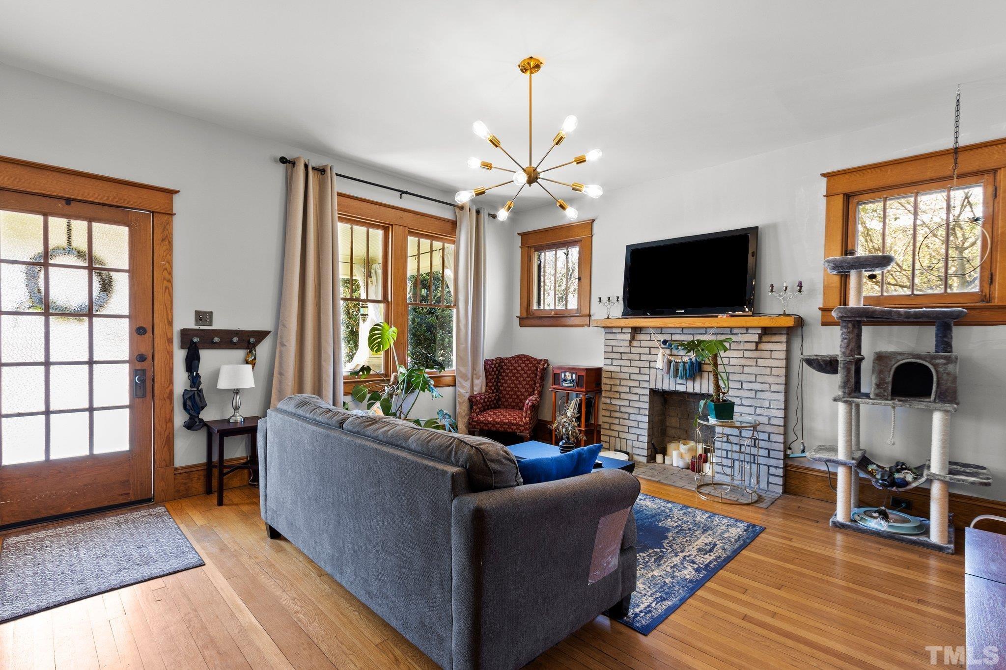 543 East Jones Street Raleigh, NC 27601 - Photo 5 of 31 a living room with fireplace furniture and a flat screen tv