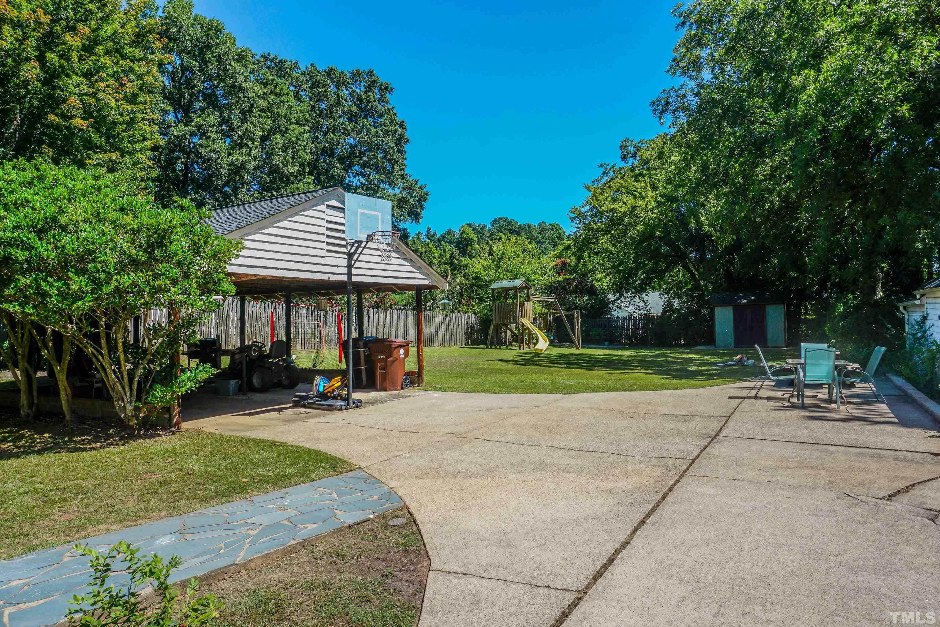 500 Gordon Street Roxboro, NC 27573 - Photo 16 of 70 a view of a patio with a table and chairs under an umbrella