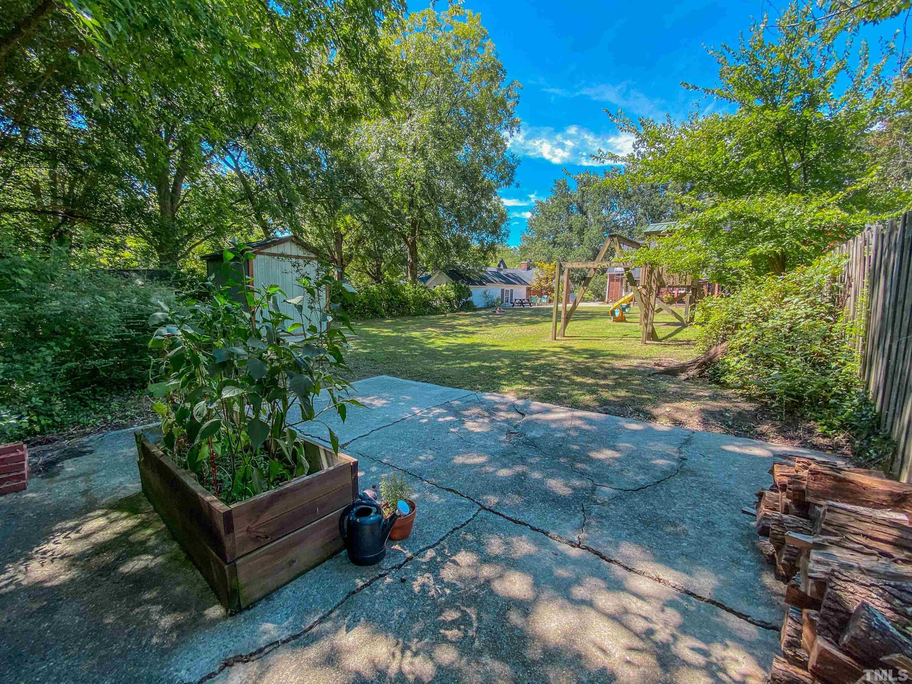 500 Gordon Street Roxboro, NC 27573 - Photo 17 of 70 a view of a backyard with couches plants and large trees