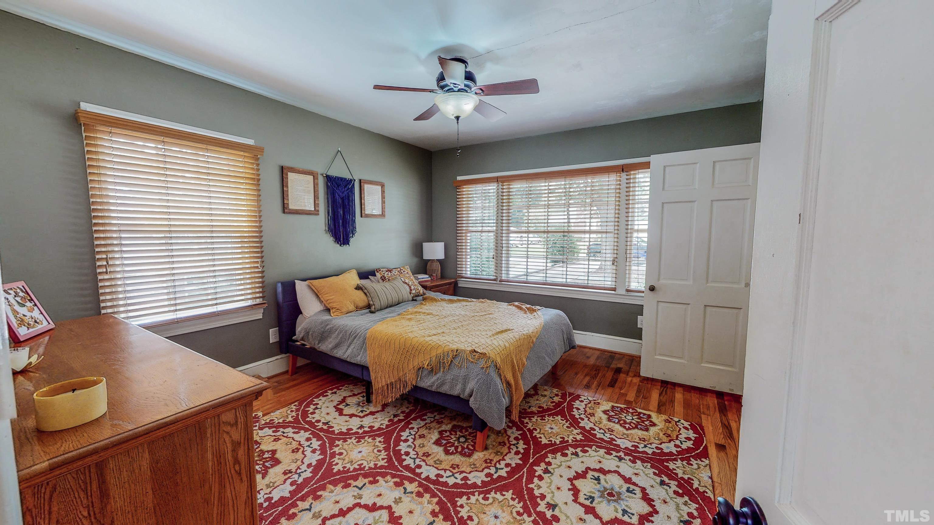 500 Gordon Street Roxboro, NC 27573 - Photo 19 of 70 a bedroom with a bed and wooden floor