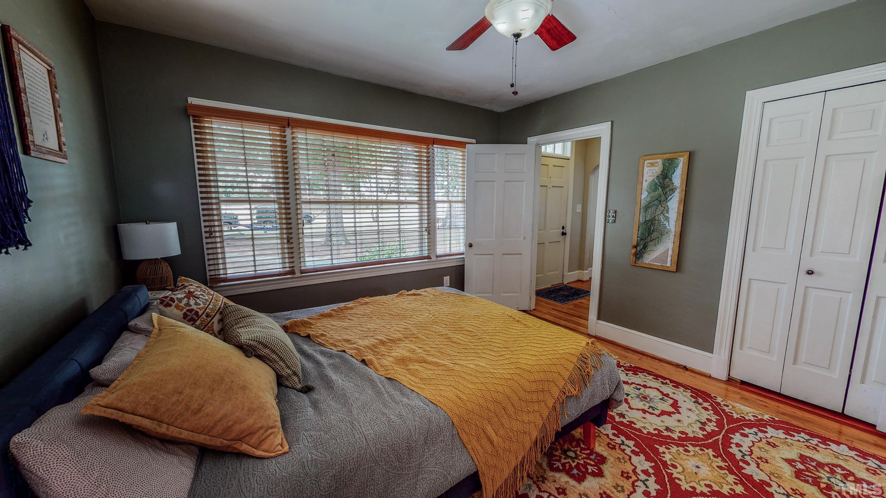 500 Gordon Street Roxboro, NC 27573 - Photo 21 of 70 a bedroom with a large bed and a chandelier