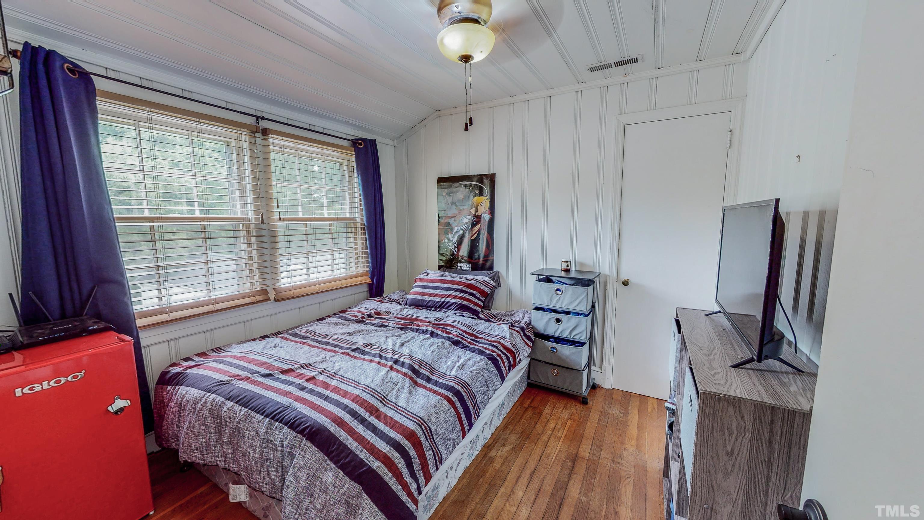 500 Gordon Street Roxboro, NC 27573 - Photo 40 of 70 a bedroom with a bed and a flat tv screen on the dresser