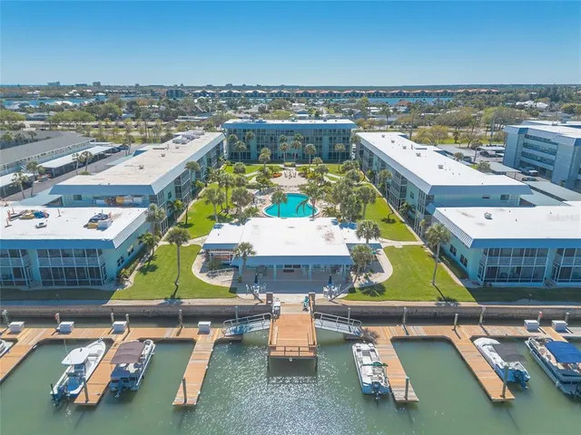 an aerial view of a building with swimming pool and ocean view