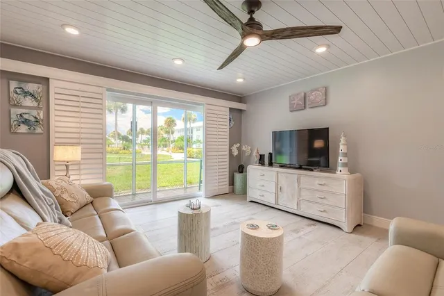 a kitchen with kitchen island stainless steel appliances dining table and chairs