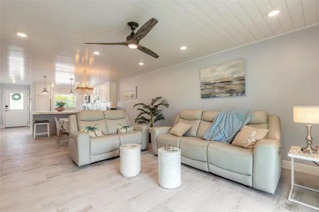 a living room with furniture and a chandelier