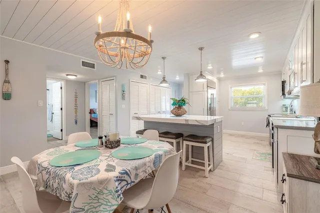 a kitchen with kitchen island white cabinets stainless steel appliances and sink