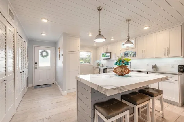a kitchen with a sink a counter space and a window