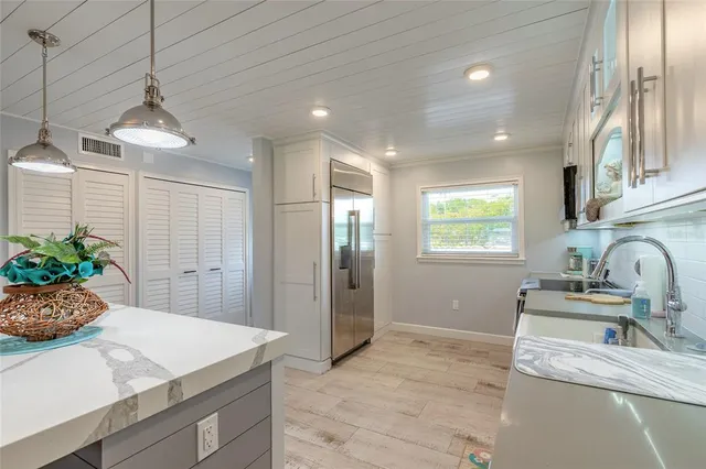 a view of a porch with chairs and backyard