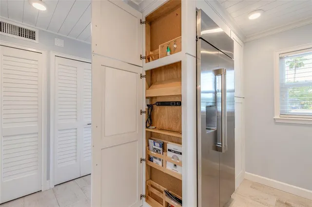 a porch area with table and chairs