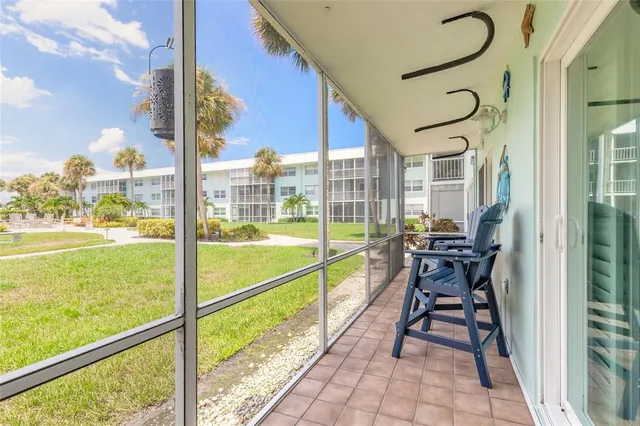 a view of a swimming pool with a table and chairs under an umbrella