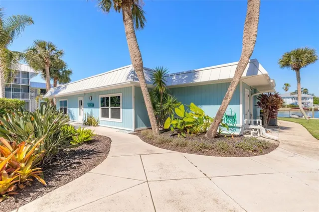 a view of a house with swimming pool and sitting area