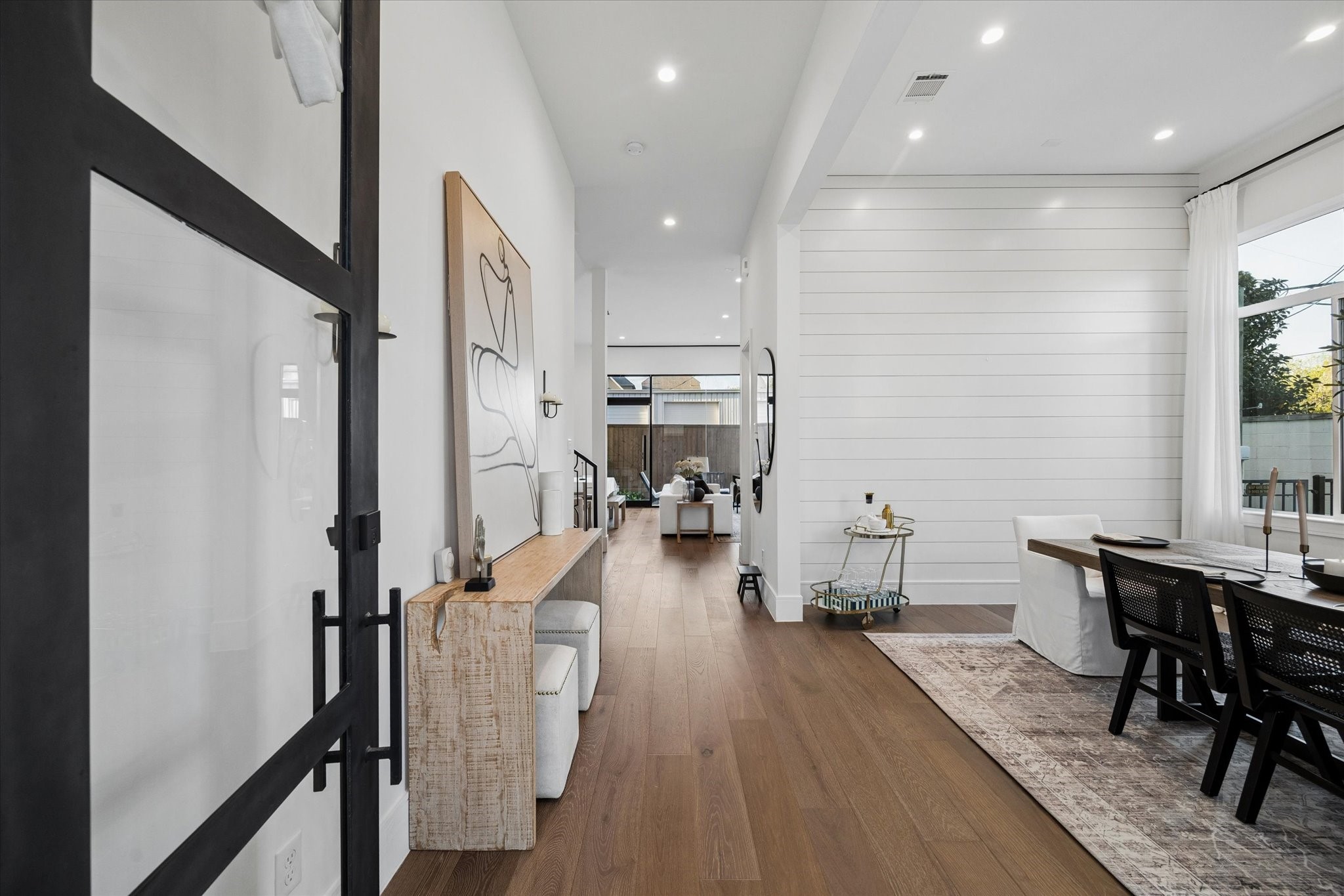 1661 Bingle Road Houston, TX 77055 - Photo 4 of 33 sprawling natural light, white oak engineered wood floors throughout the first floor. shiplap accents. updated lighting and fresh interior paint including all main floor, stair walls and baseboards (Sept 2024)